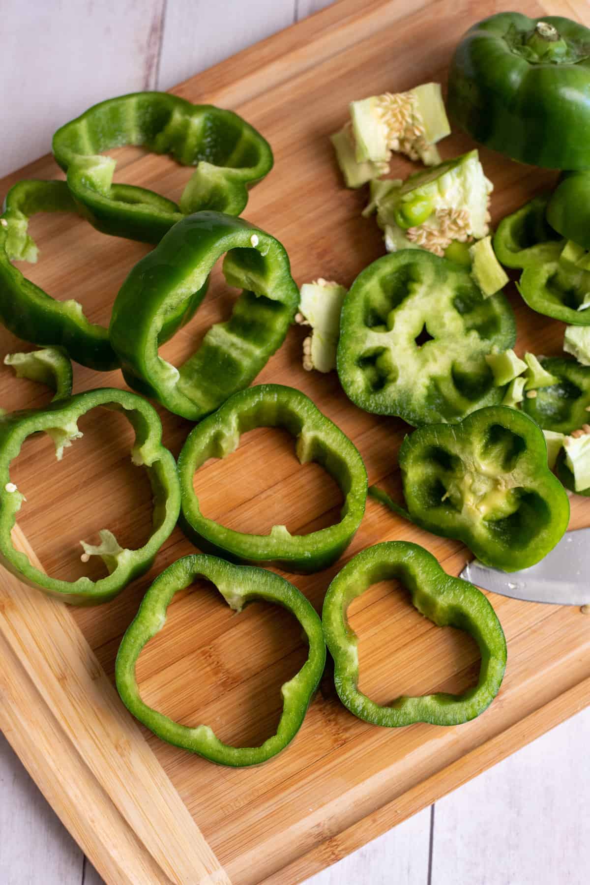 Cut tops and bottoms off green bell peppers.