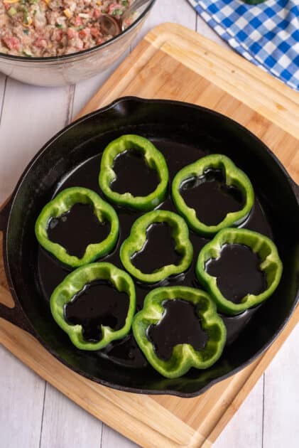 Place the pepper rings into the hot skillet.