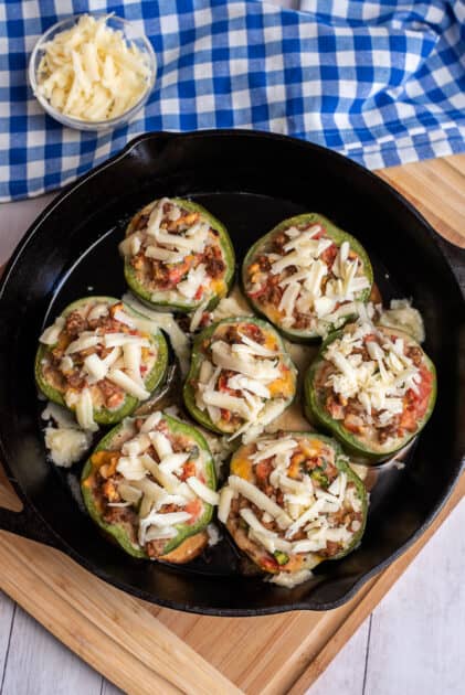 Top pepper rings with shredded mozzarella cheese.