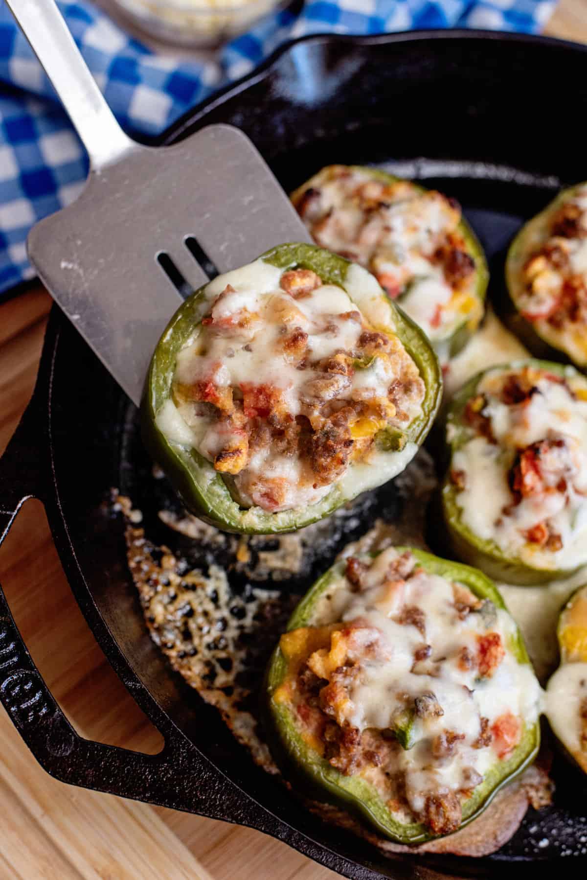 Remove sausage stuffed peppers with a spatula.
