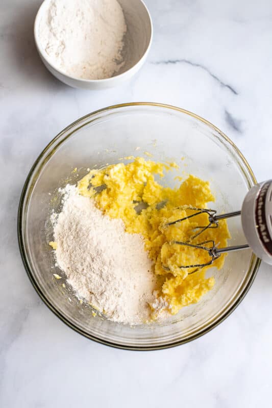 add half the flour to the butter mixture