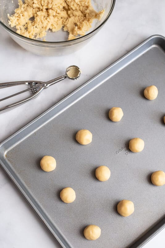using cookie scoop form balls and set on sprayed cookie sheet