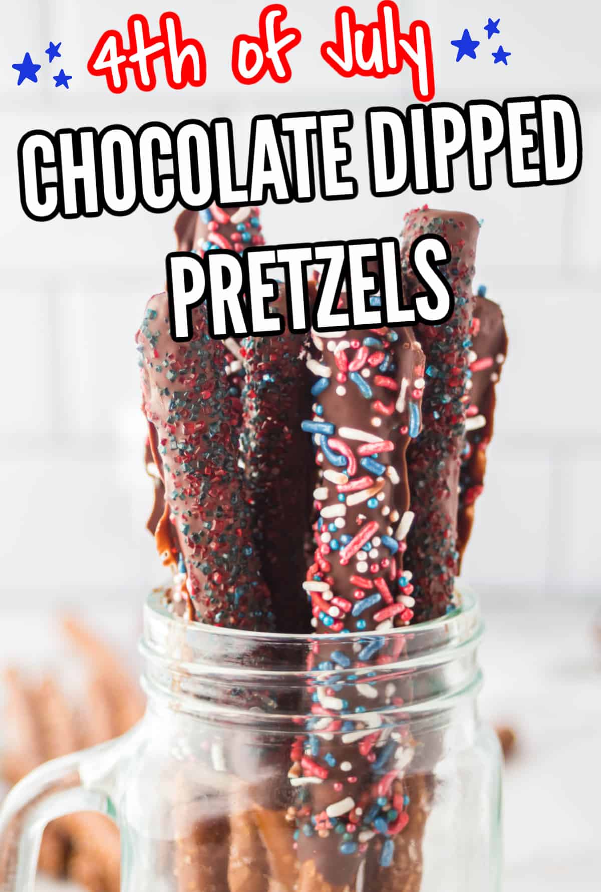 Chocolate dipped pretzel rods in a mason jar on counter