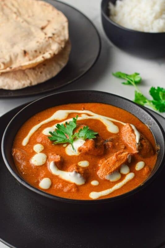 Indian butter chicken in a bowl on table 