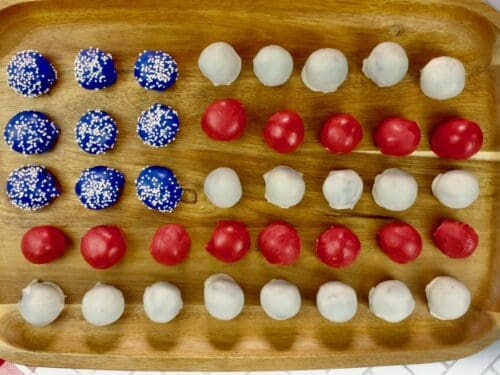 4th of July Oreo balls on a wooden serving tray.
