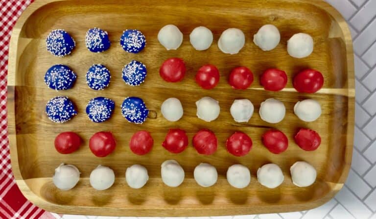 4th of July Oreo balls on a wooden serving tray.