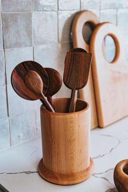 Collection of wooden spoons in wooden container (wooden spoon uses).