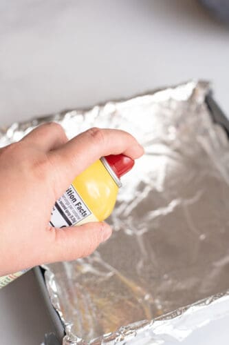 Spray foil on pan with oil