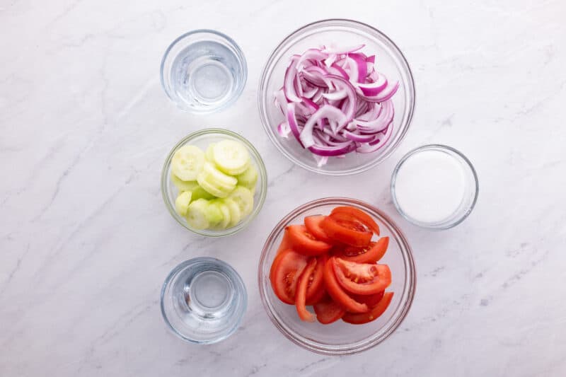 Recipe ingredients for tomato, onion, and cucumber salad.