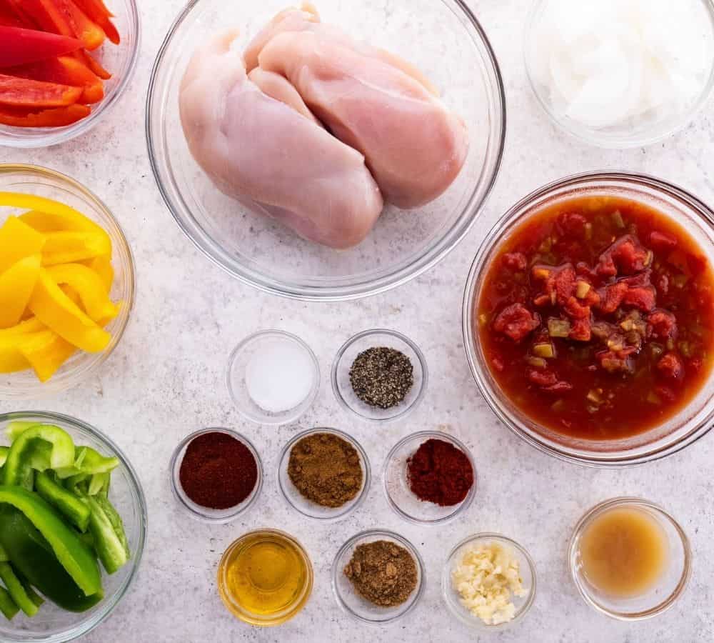 ingredients for making chicken fajitas on marble counter 