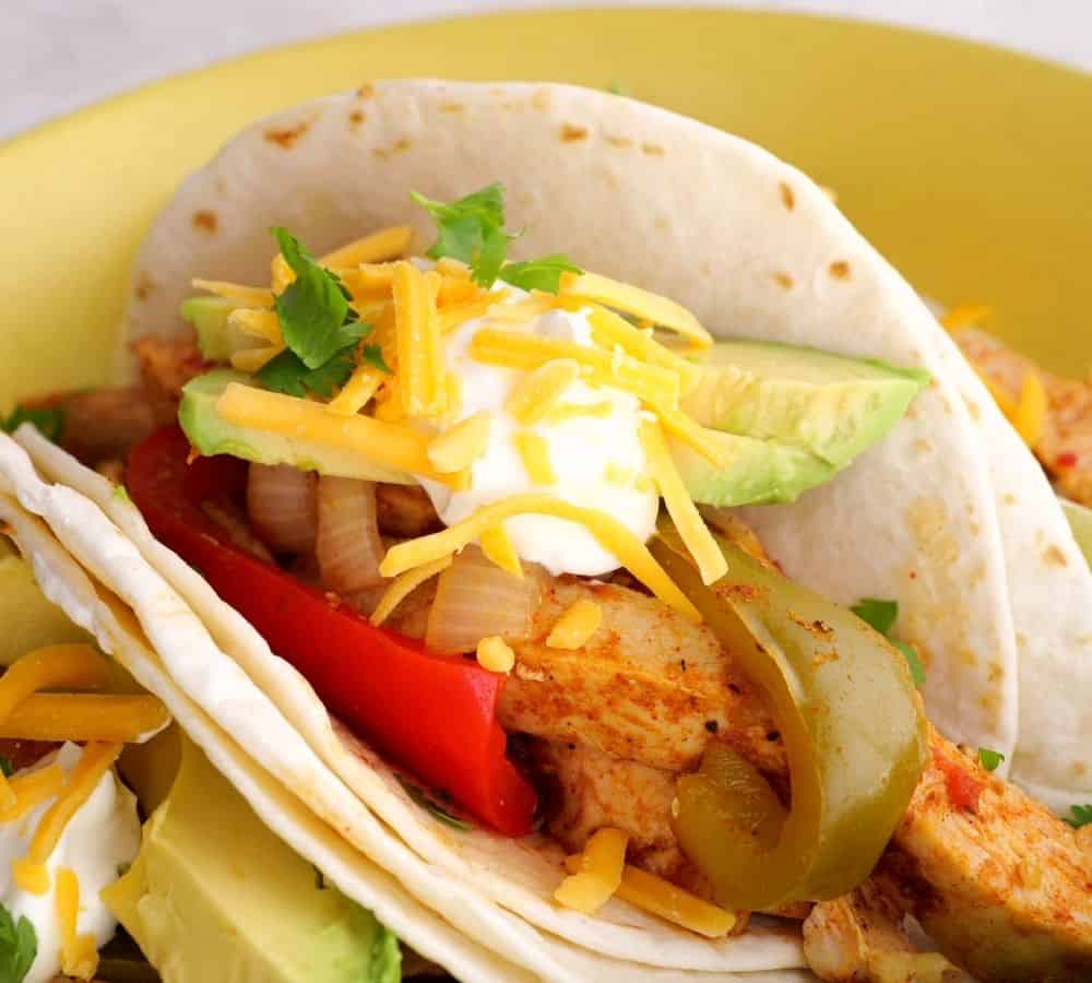 side view of fajitas on a yellow plate