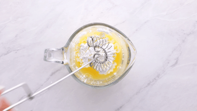 Whisking cornstarch with orange juice.