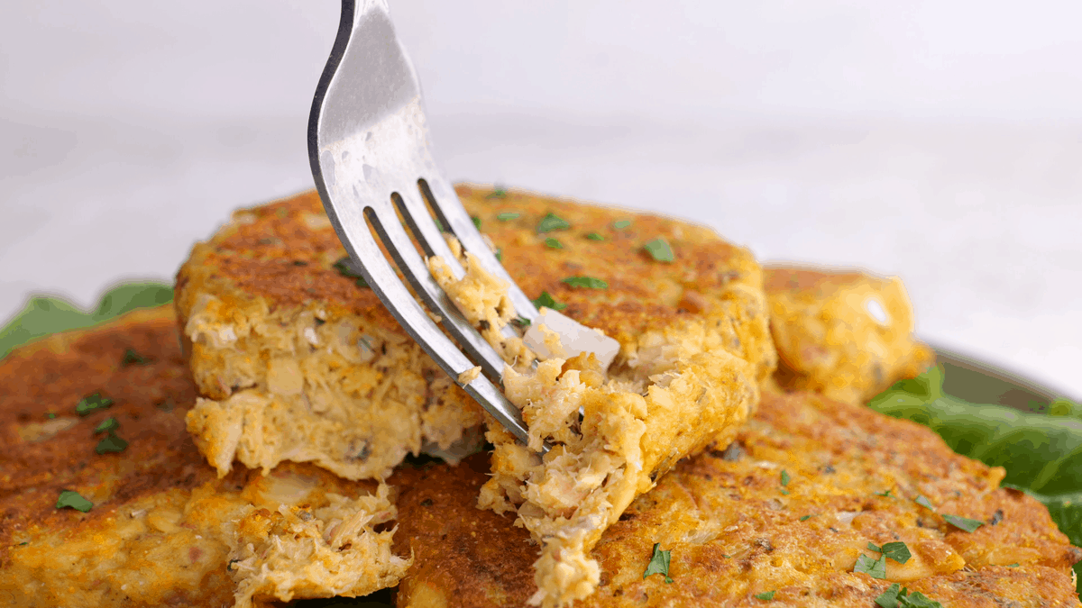 Fork breaking into a salmon patty