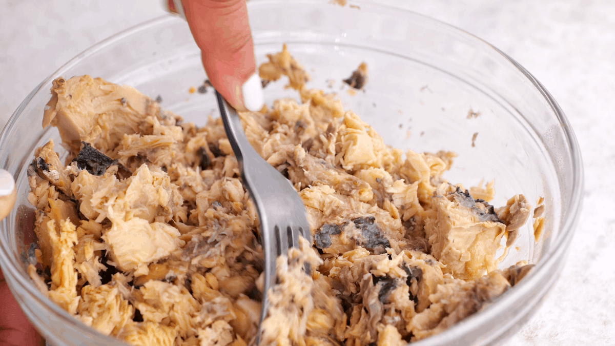 Loosening salmon with a fork.