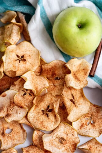 Layer of baked apple chips on counter.