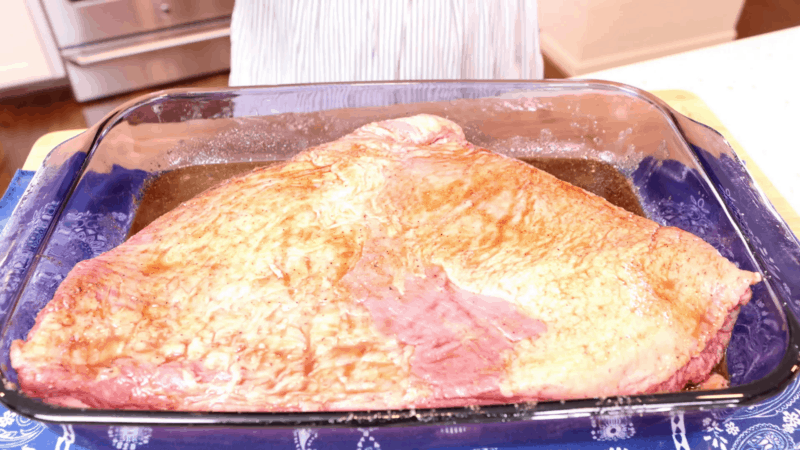 Brisket fat side up in baking dish.