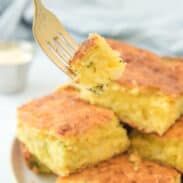 Fork with a bite of broccoli cheese cornbread.