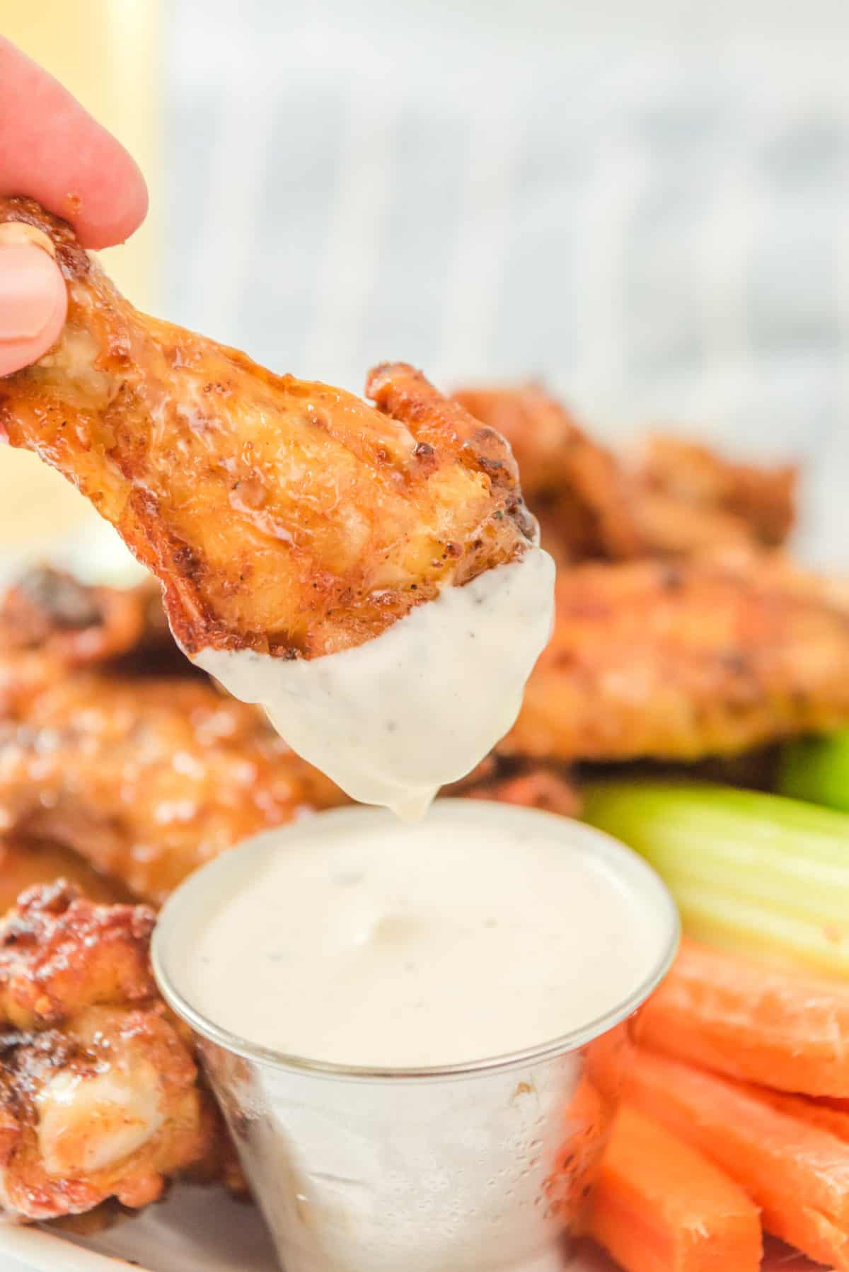 BBQ air fryer chicken wing dipped in ranch dressing.