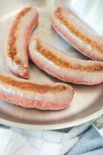 Brown sausages in skiller.