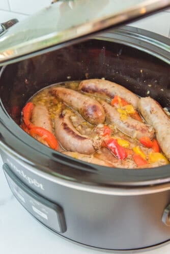 Cooking sausages and pepper in crockpot.