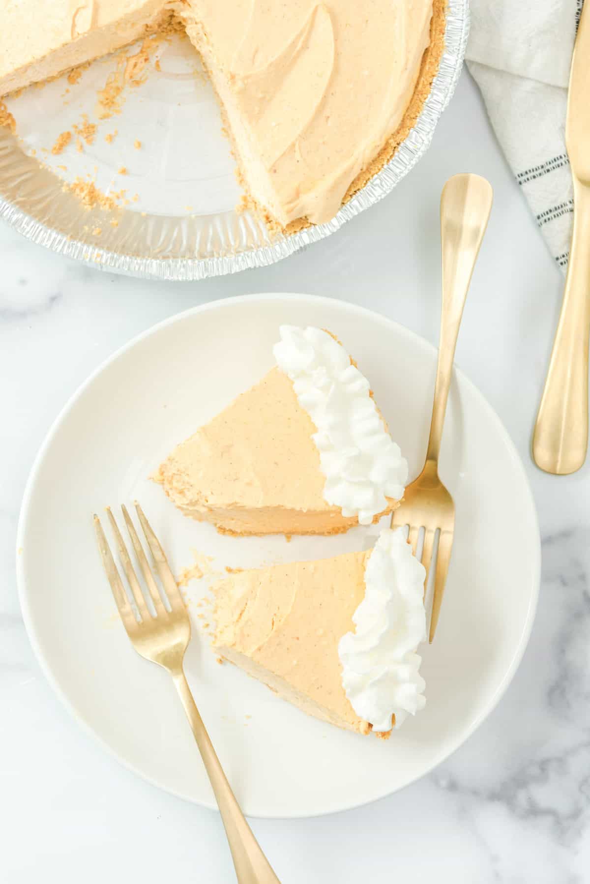 Two slices of no-bake pumpkin cheesecake on plate.