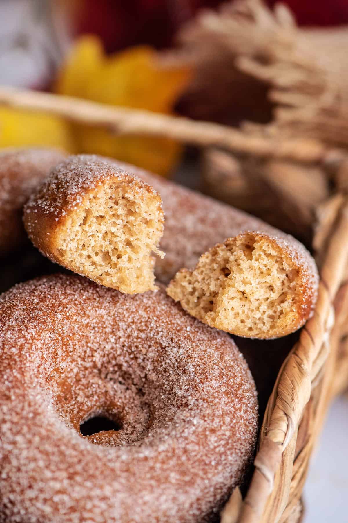 Bite taken out of baked apple cider donut (apple recipes for fall).