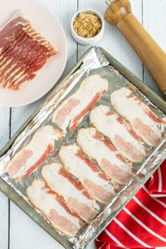 Strips of bacon on baking sheet.