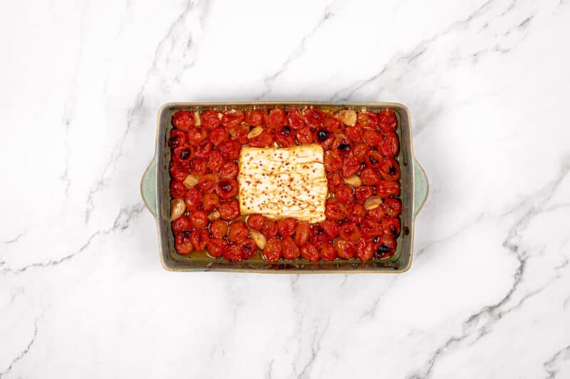 Baked feta and tomatoes in oven tray.