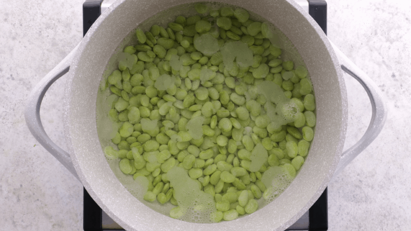 Butter beans boiling on stovetop.