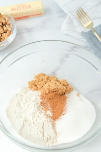 Mix walnut crumble topping ingredients in bowl.