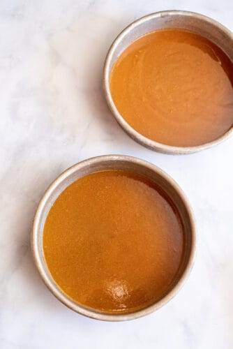 Pecan praline poured into cake pans.