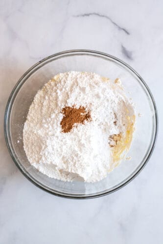 Cream cheese frosting ingredients in mixing bowl.