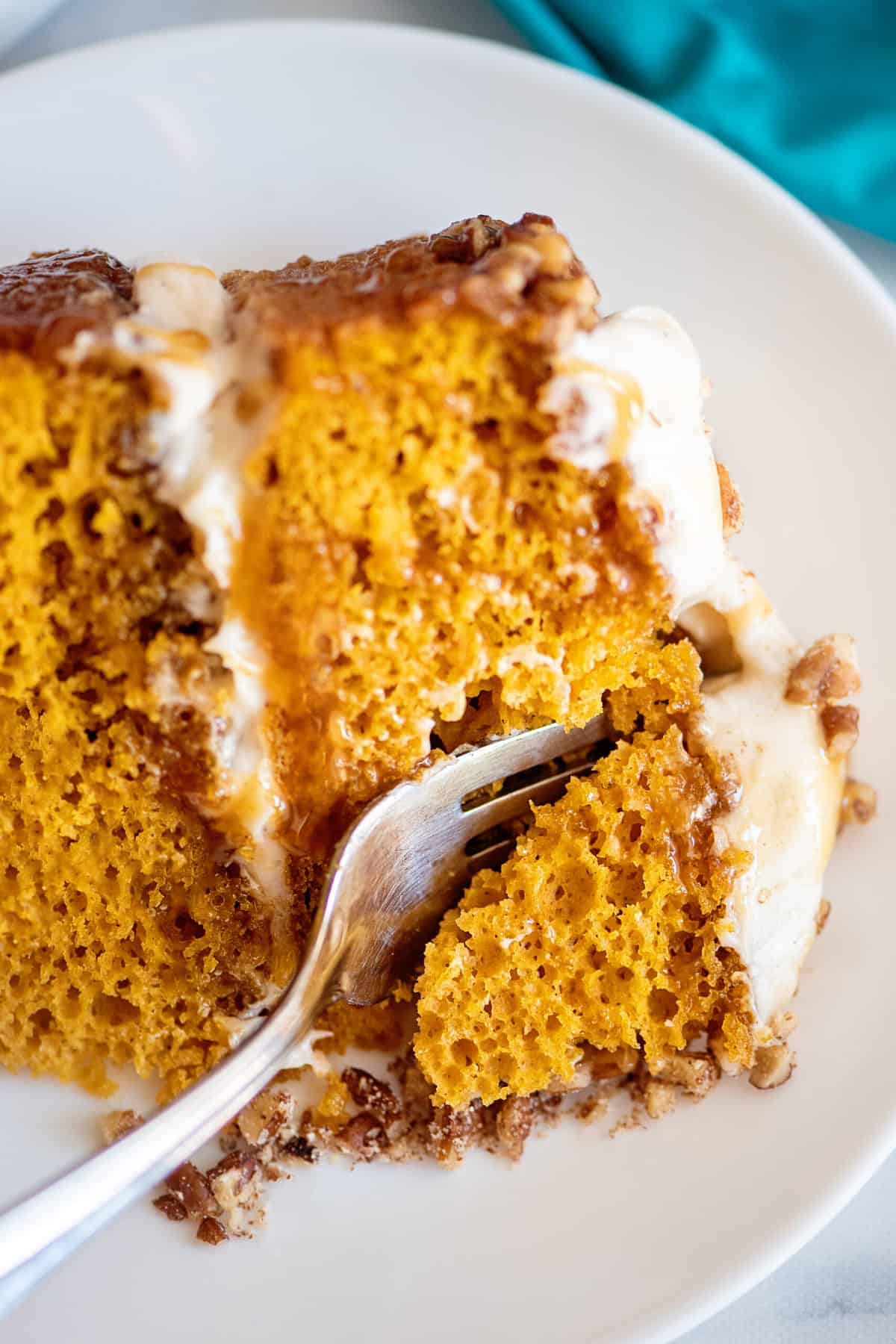 Fork in a slice of pumpkin praline cake.