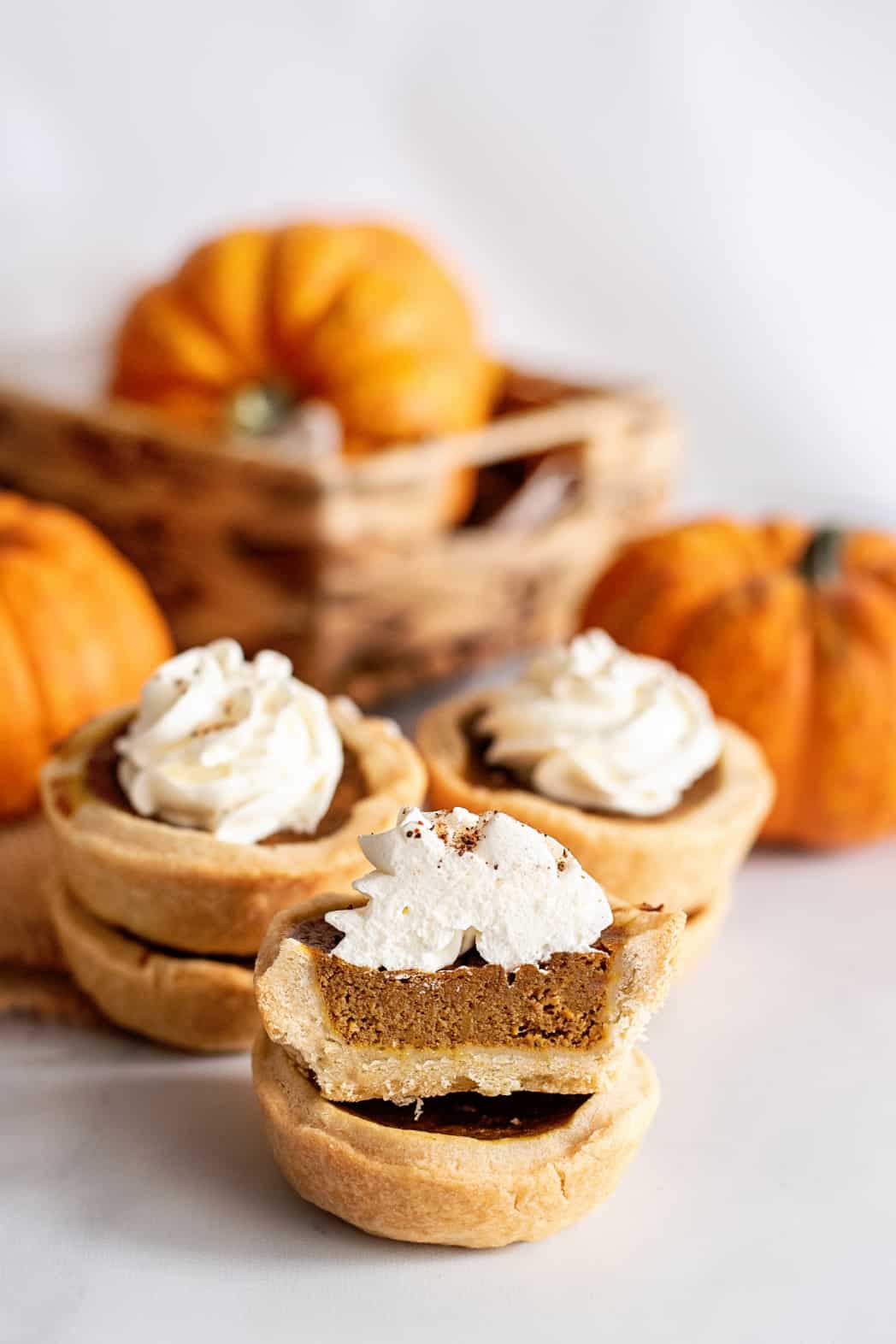 Stack of mini pumpkin pies.