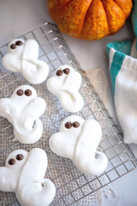 ghost cookies cooling on baking sheet