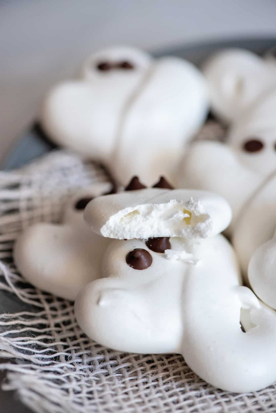 Bite out of ghost meringue cookies.