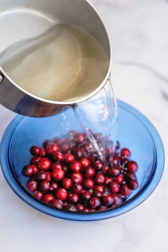 Pour sugar syrup over cranberries.