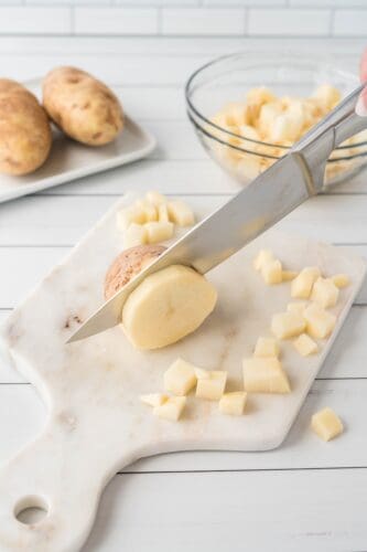 Peel and dice potatoes.