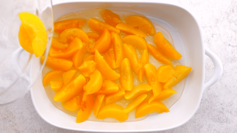 Canned peaches in baking dish.