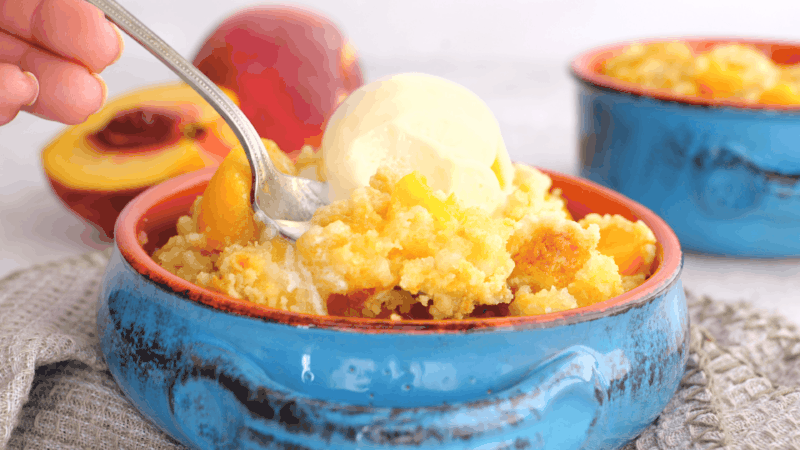 Scoop of peach dump cake.