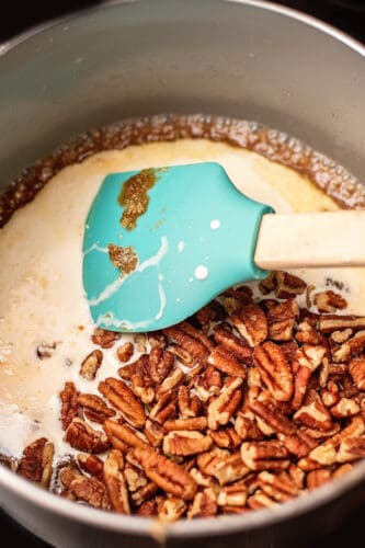 Add pecans and cream to saucepan.