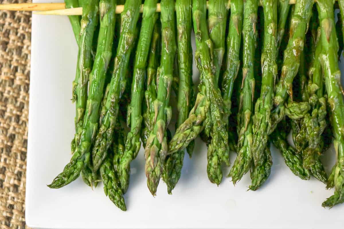 Close-up of grilled asparagus on plate.