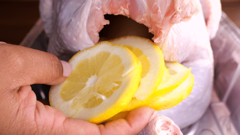 Stuffing turkey with lemon slices.