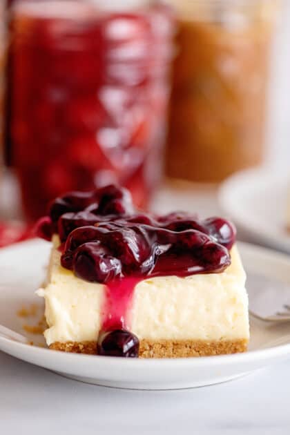 Slice of cheesecake with blueberry topping.