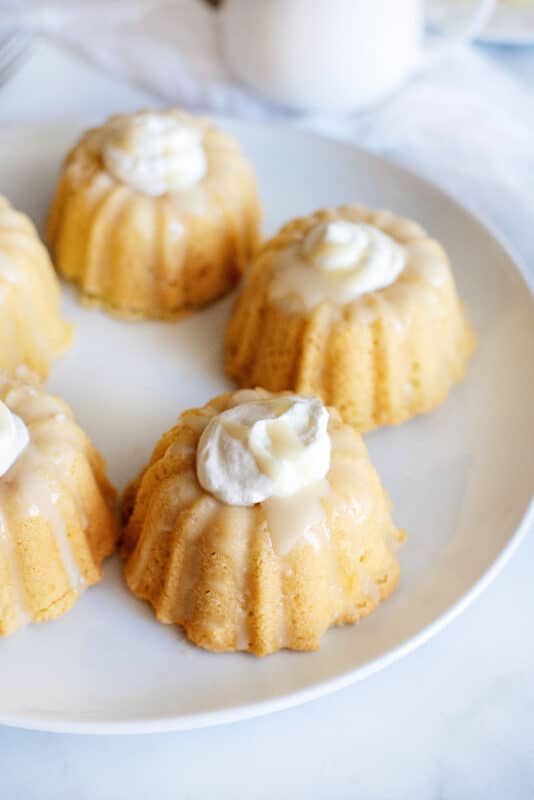 Mini bundt cakes with icing and whipped cream.