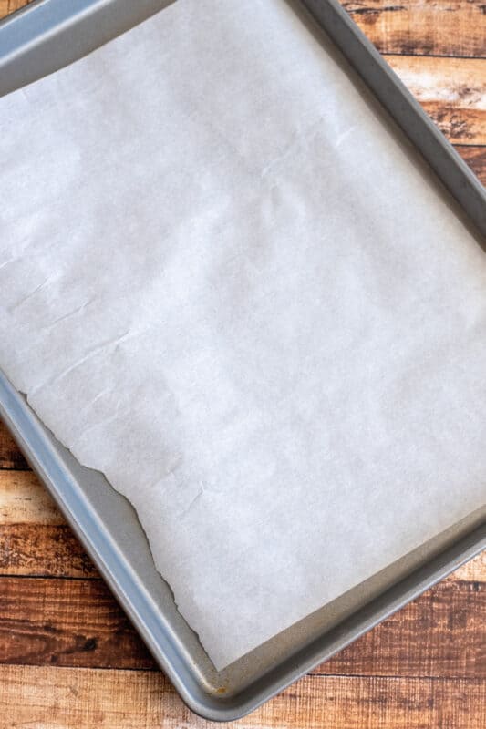 Line baking sheet with parchment paper.