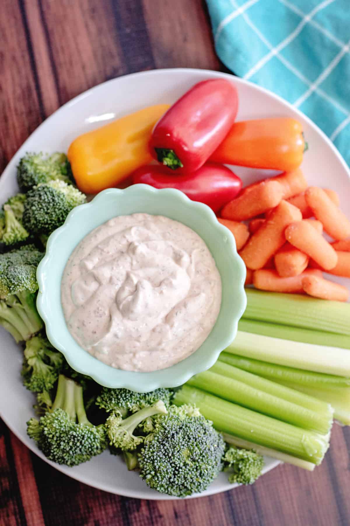 Chipotle ranch dressing surrounded by vegetables on serving plate.