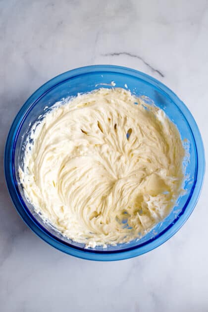 Creamy cheesecake mixture in mixing bowl.