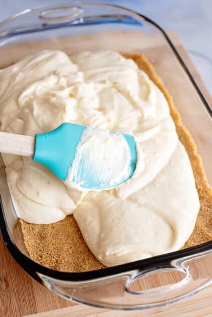 Spread cheesecake batter over crust.