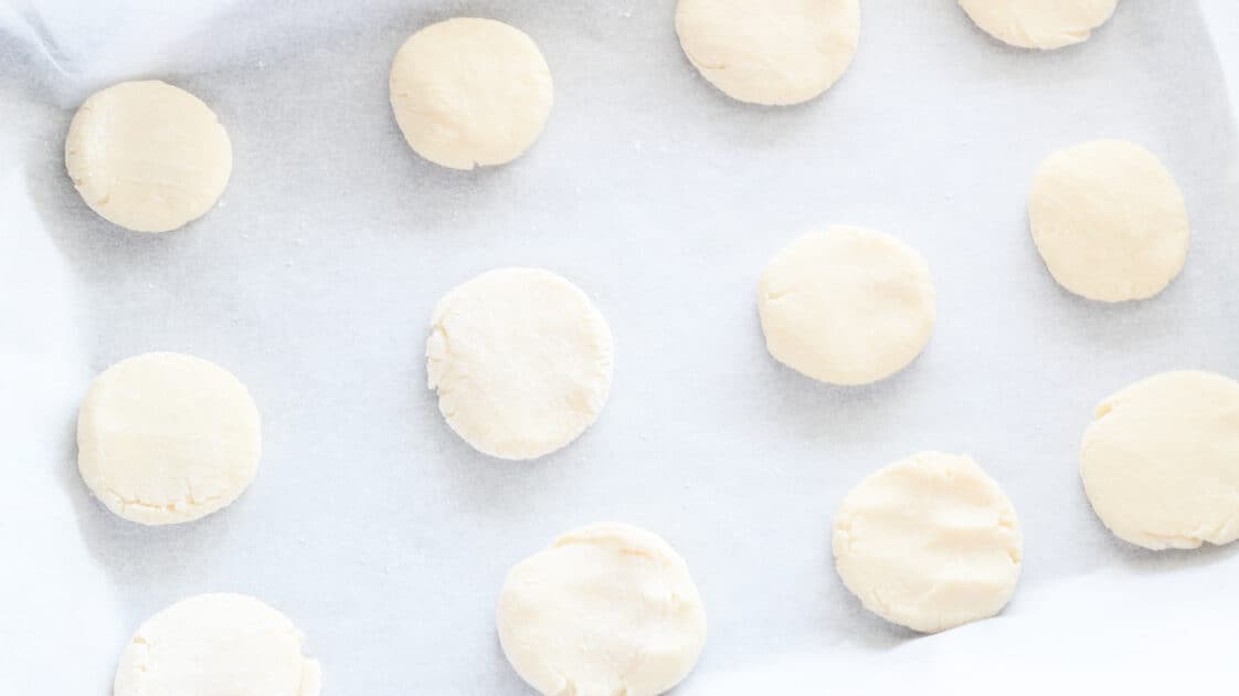 Flatten balls of dough with palm of hand.